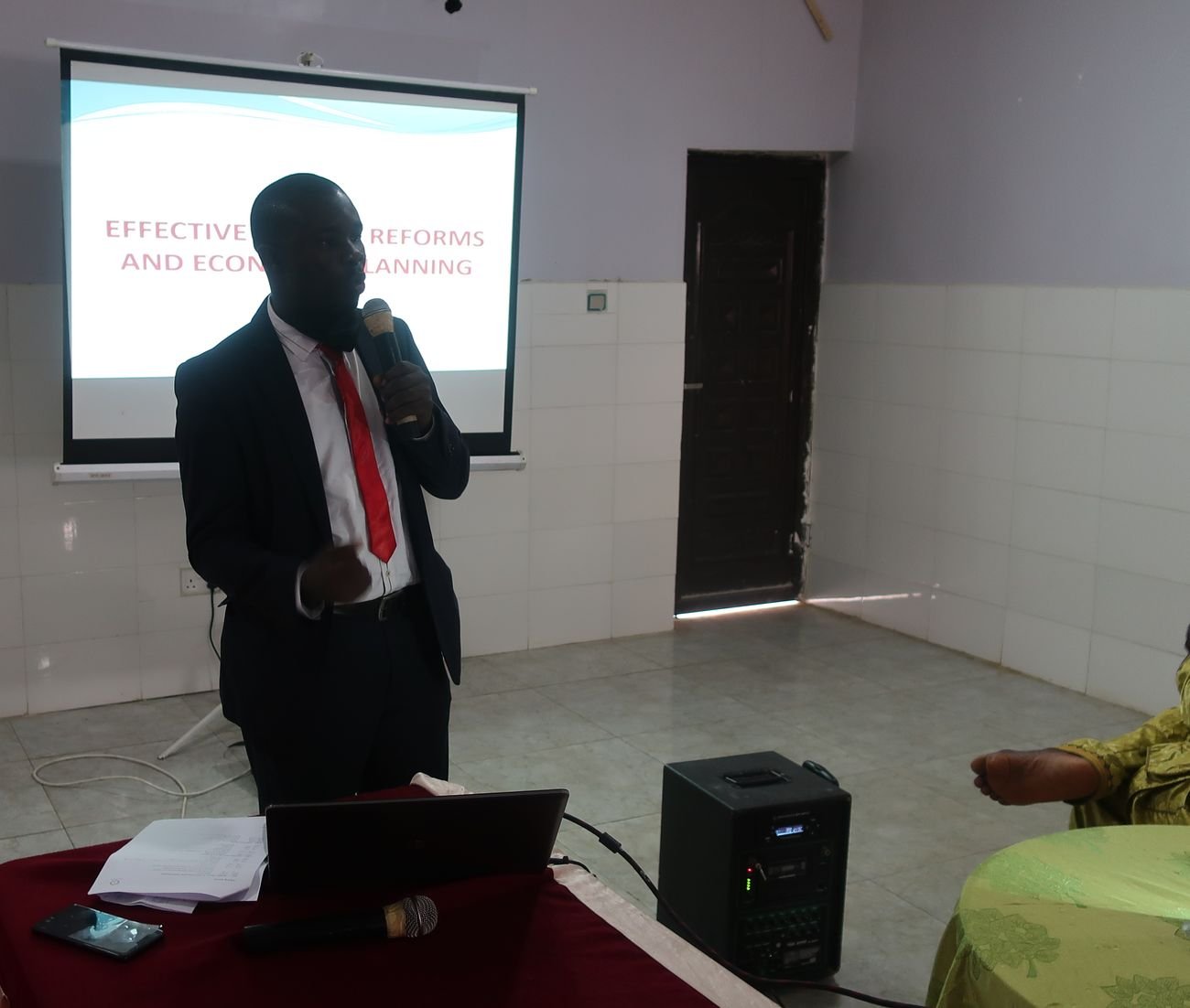 A facilitator presenting Effective Budget Reforms and Economic Planning